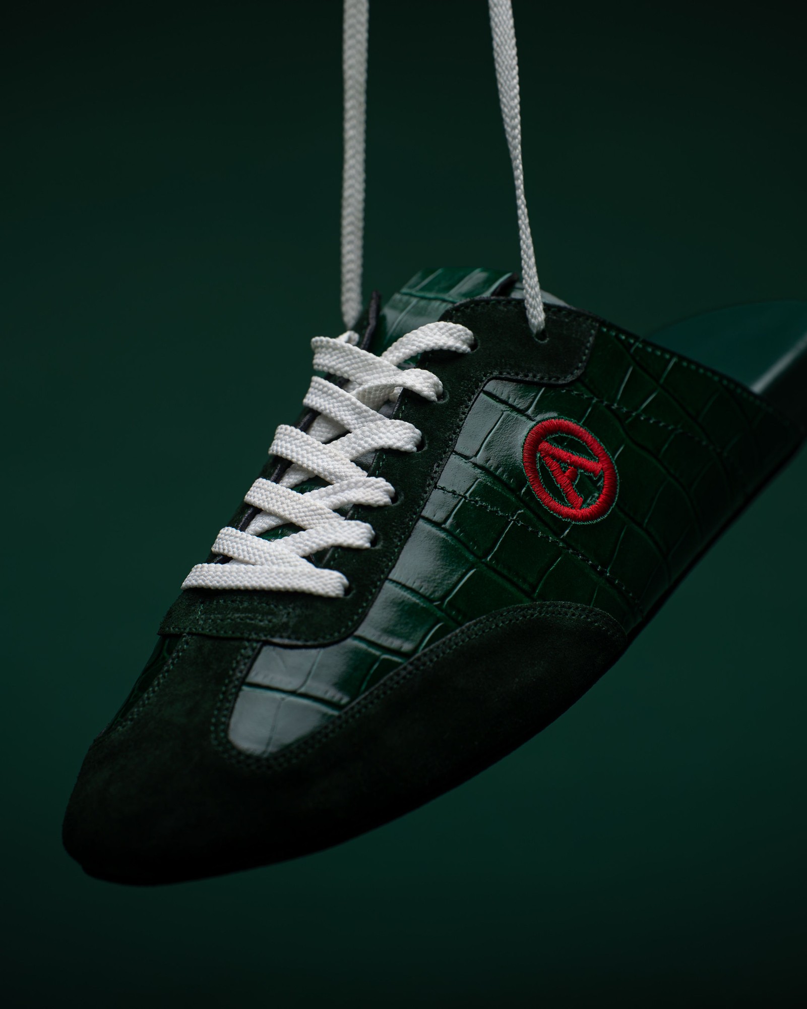 Close view of the Eko Goose forest green slide, laces and embroidered A