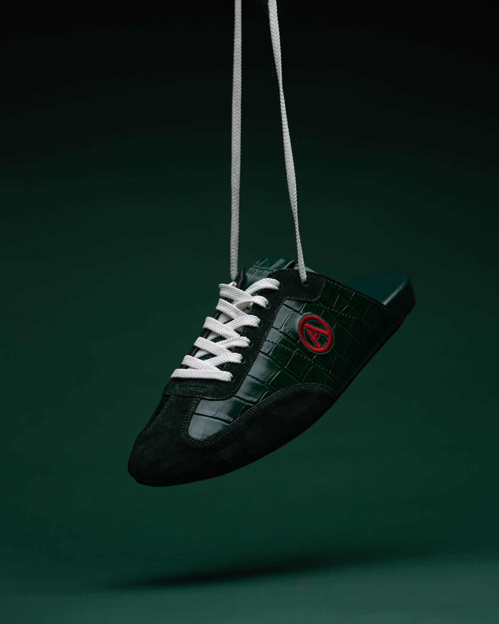 Eko Goose forest green slide hanging from white laces